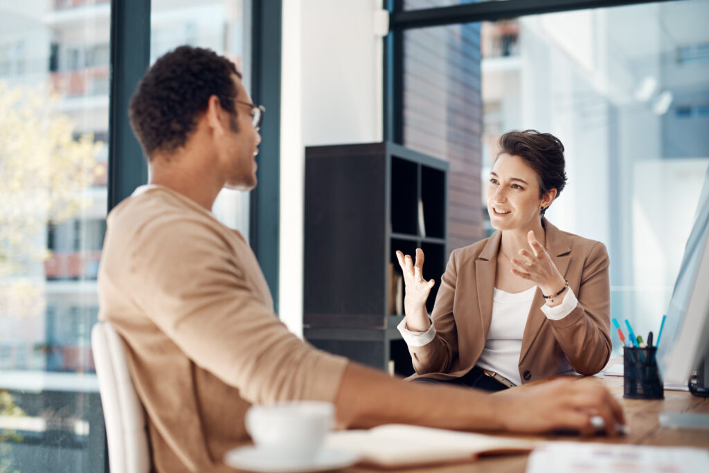 Mentor, training and a woman manager with an employee in the office for coaching on company vision. Management, meeting and a female business person talking to a professional male colleague at work AdobeStock 603261551
